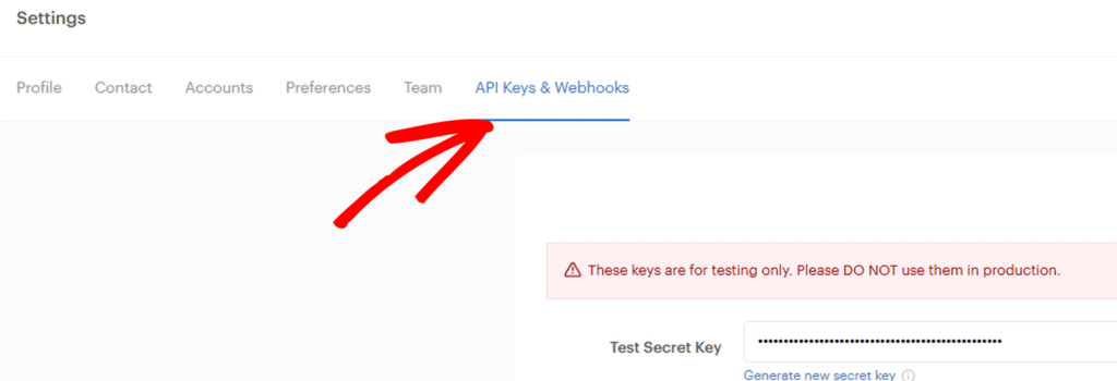 Settings page showing API Keys & Webhooks tab selected with blue underline; warning banner about test keys; form shows Test Secret Key with masked value and 'Generate new secret key' link on the side.